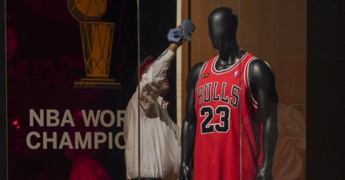 Michael Jordan's 1998 finals game jersey from his "Last Dance" season is displayed in a glass case, highlighting Sotheby's sports memorabilia auction dubbed "Invictus," New York City, U.S., Sept. 6, 2022. (AP Photo)