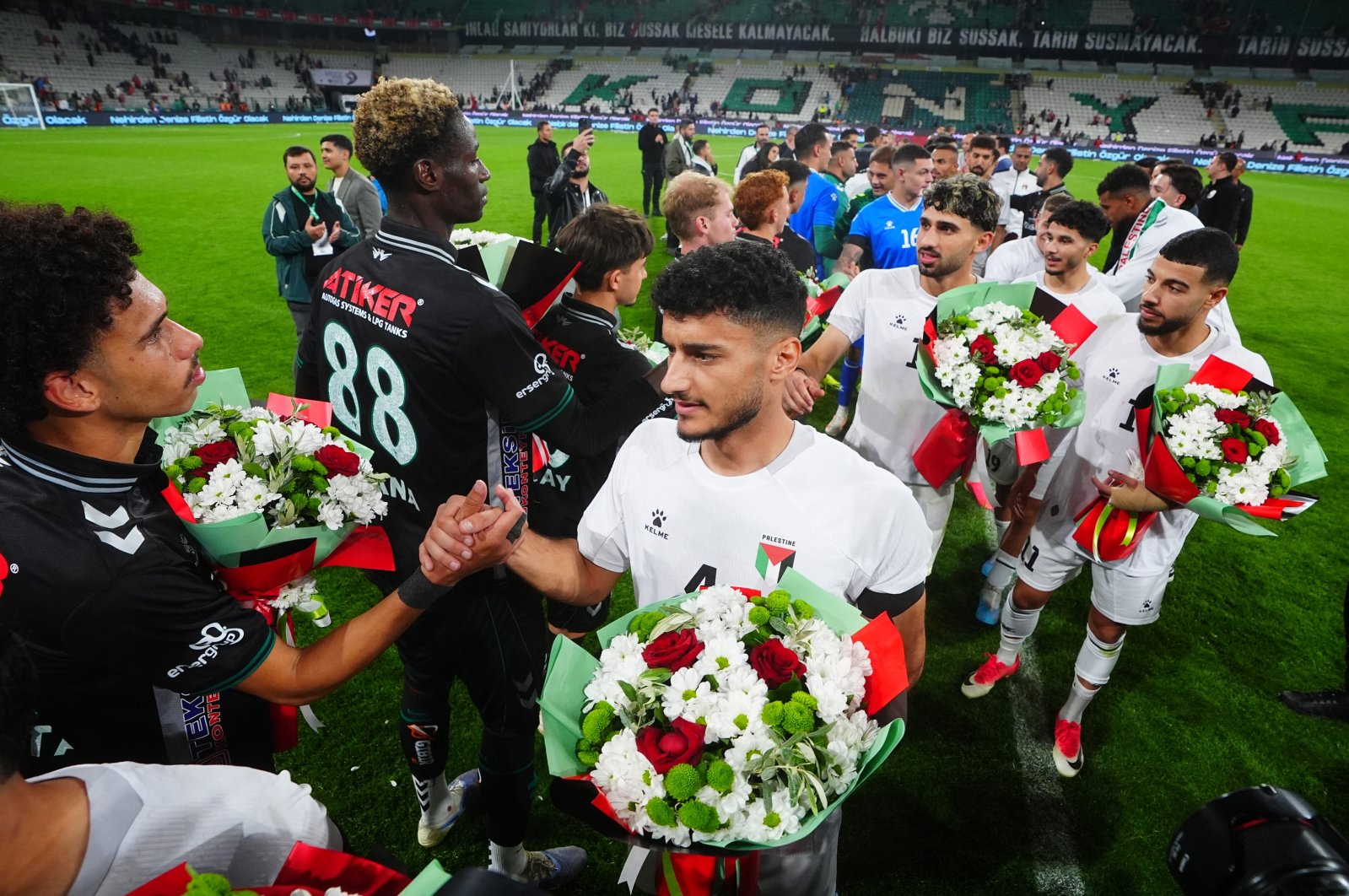 Konyaspor and Palestine national team players exchange flowers after the friendly match at Konya Büyükşehir Stadium, Konya, Türkiye, Sept. 30, 2026. (AA Photo)