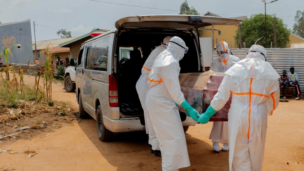 Members of the Civil Protection carry a wooden coffin before loading the body of an unidentified man who died of Ebola, Ituri Province, DRC, July 10, 2026. (Reuters Photo)