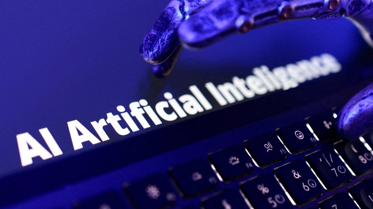 The words "AI Artificial Intelligence," a keyboard and a robotic hand are shown in this illustration, June 5, 2026. (Reuters Photo)