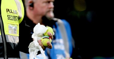 Stewards and security pick up tennis balls with the Palestinian flag stuck on them during the UEFA Nations League match between the Republic of Ireland and Austria, Dublin, Ireland, Oct. 1, 2026. (EPA Photo)