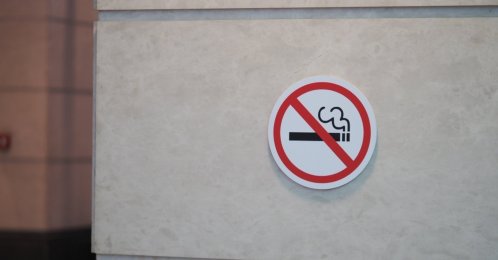 A no-smoking sign hangs on a wall in a public area. (Shutterstock Photo)
 
