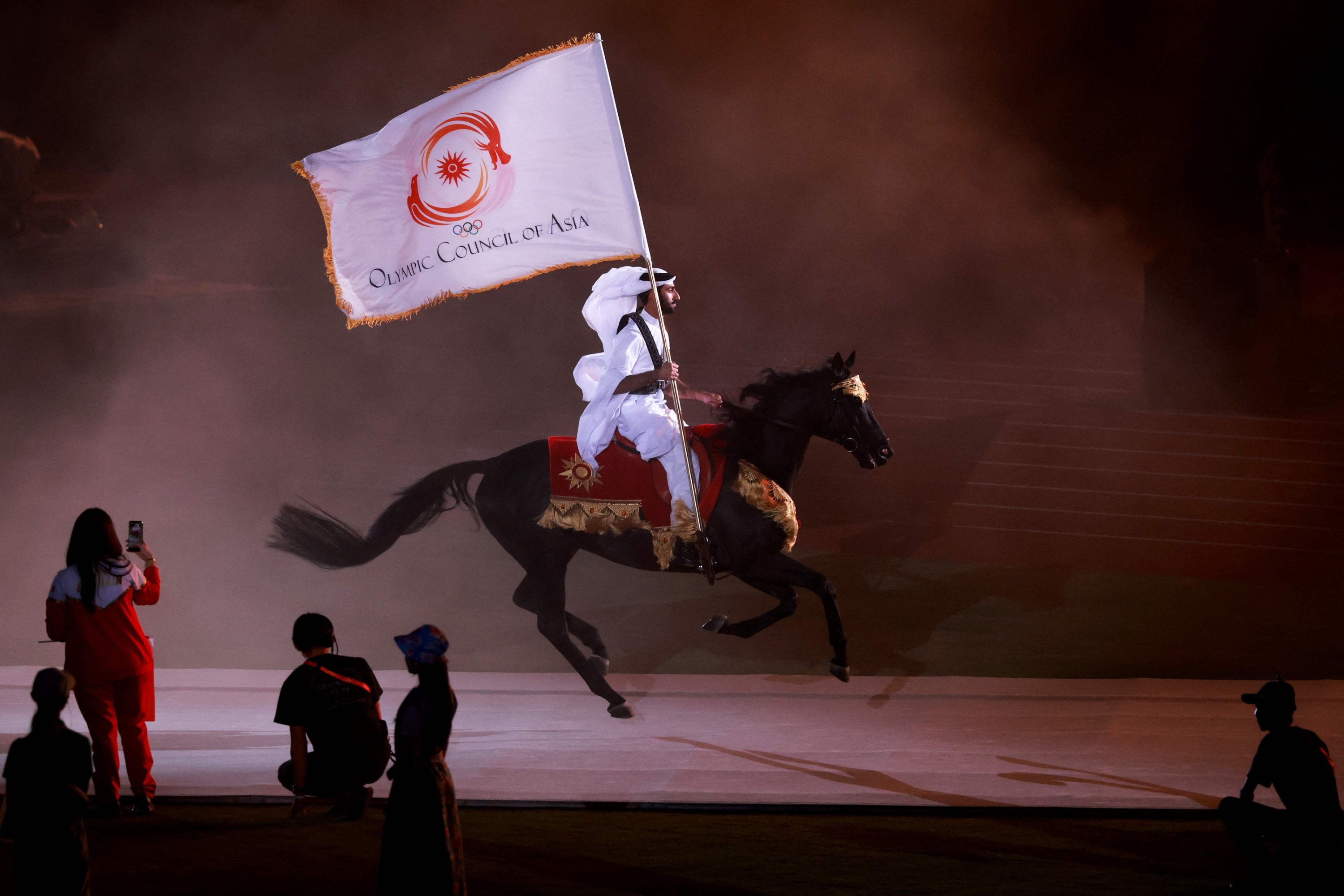 A performer rides a horse with the Olympic Council of Asia (OCA) flag during the closing ceremony of the 2026 Asian Games in Nagoya, Japan, Oct. 4, 2026. (AFP Photo)