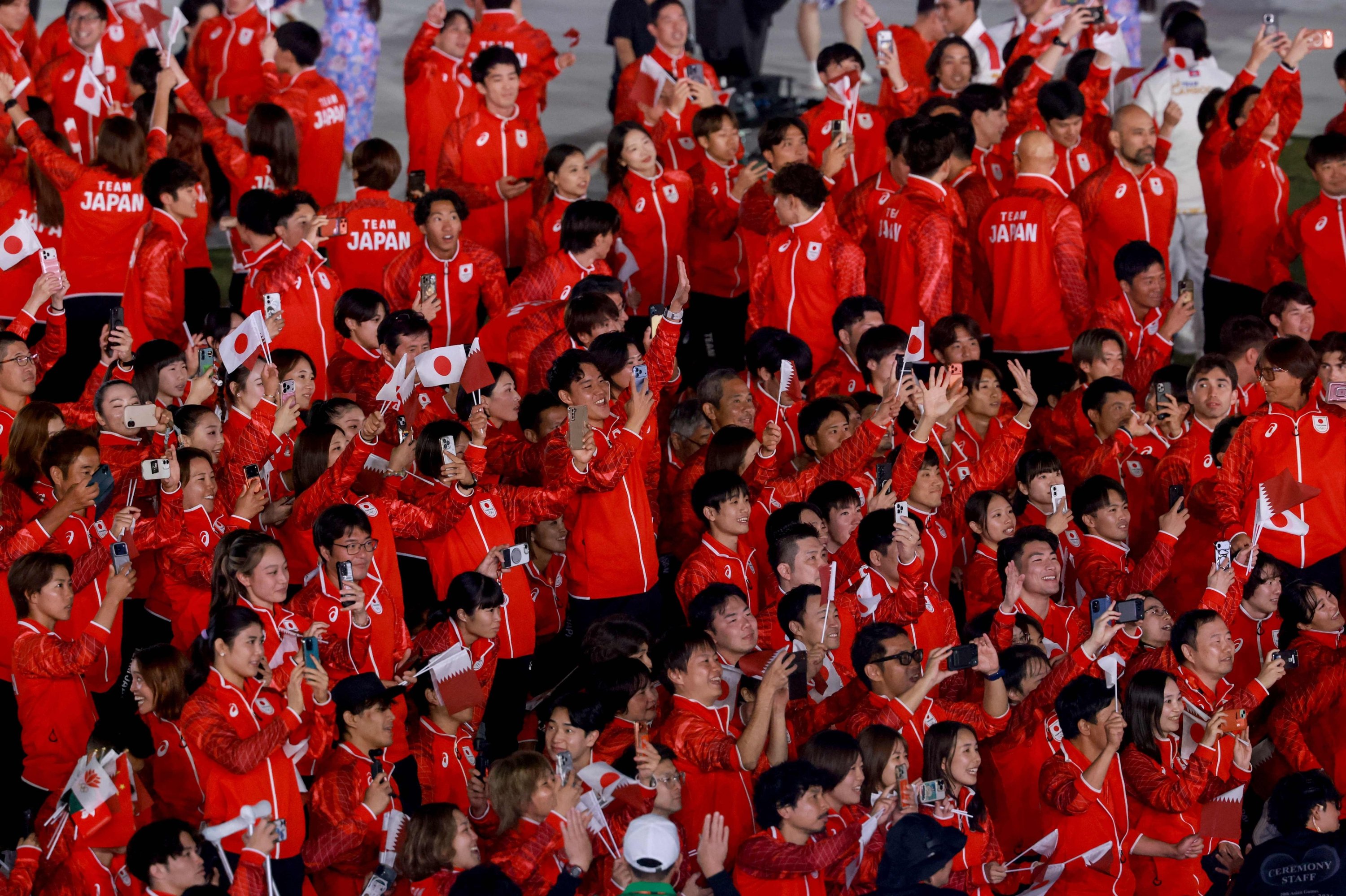 Members of the Japan contingent enjoy a performance during the closing ceremony of the 2026 Asian Games, in Nagoya, Japan, Oct. 4, 2026. (AFP Photo)
