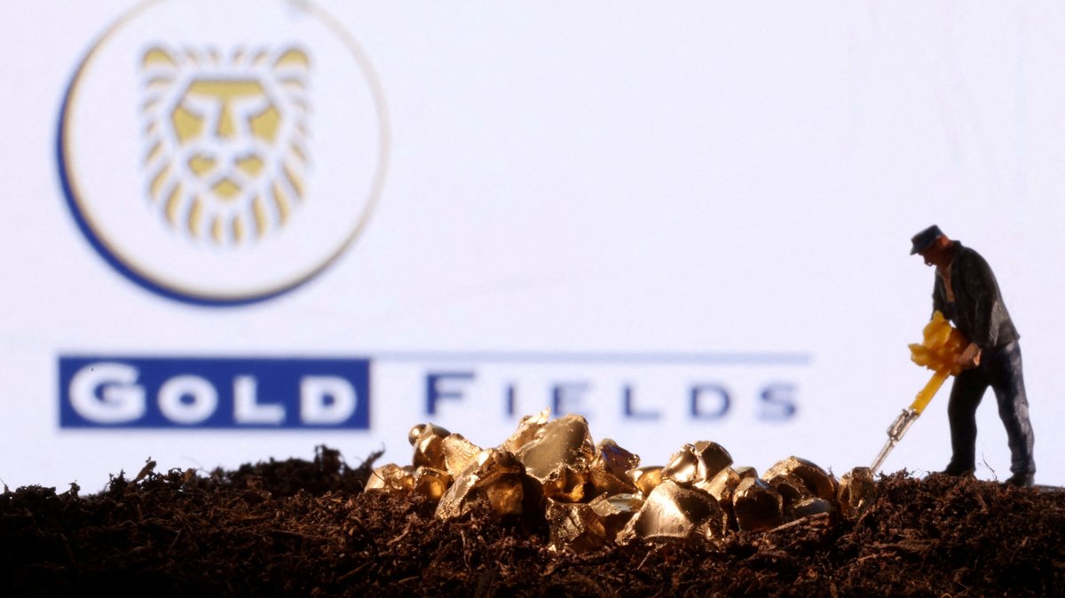 A small toy figure and gold imitation are seen in front of the Gold Fields logo in this illustration taken Nov. 19, 2021. (Reuters Photo)