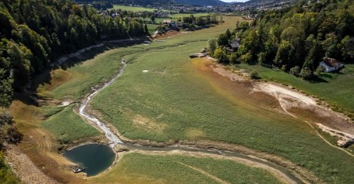 An aerial view of the bed of Lake Brenets, parched and now covered in grass, and a part of the Doubs River forming a natural border between eastern France and western Switzerland, Les Brenets, Switzerland, Sept. 25, 2026. (AFP Photo)