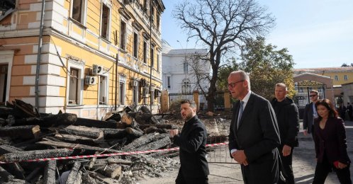 Ukraine's President Volodymyr Zelenskyy, German Chancellor Friedrich Merz visit the site of an administrative building of Ukraine's National Academy of Sciences hit during recent Russian drone strikes, in Kyiv, Ukraine, Oct. 4, 2026. (Reuters Photo)