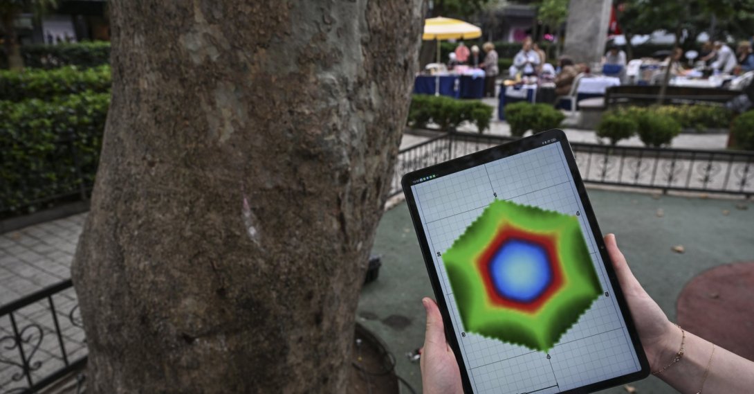 A tablet displaying acoustic tomography data is seen next to a tree, Istanbul, Türkiye, Sept. 17, 2026. (AA Photo)