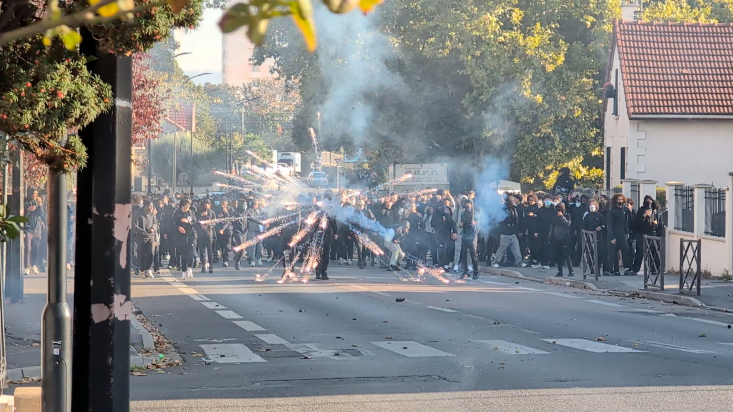A protester launches a firework during clashes with the police in the streets near Paris, in Sartrouville, France, Oct. 5, 2026. (Reuters Photo)