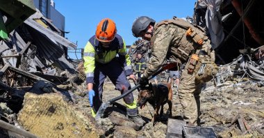 Rescuers with a dog work at the site of a shopping center destroyed by a Russian drone attack in the city of Kryvyi Rih, Dnipropetrovsk region, Ukraine, Aug. 22, 2026. (Reuters Photo)