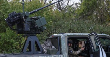 A serviceman of the 1030th Separate Anti-Aircraft Missile and Artillery Regiment 'Aquila' checks an Australian-made "Slinger" automated turret during his combat shift, amid Russia's attack on Ukraine, in Kharkiv region, Ukraine, Sept. 26, 2026. (Reuters Photo)