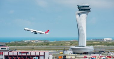 Turkish Airlines airplane with air traffic control tower of Istanbul Airport, Istanbul, Türkiye, June 3, 2023. (Shutterstock Photo) 