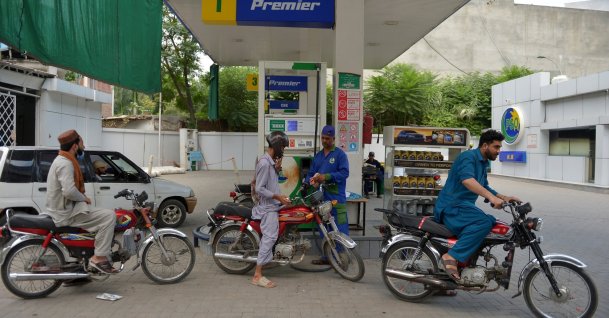 A worker refuels a customer's motorcycle at a gas station in Peshawar, Pakistan, Sept. 24, 2026. (EPA Photo)