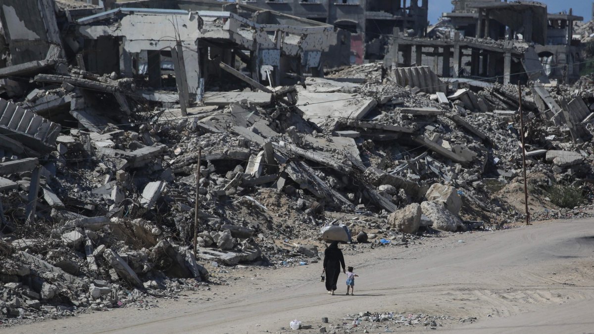 People walk along a street lined with destroyed buildings at the Jabalia refugee camp in the northern Gaza Strip, Palestine, Oct. 5, 2026. (AFP Photo)