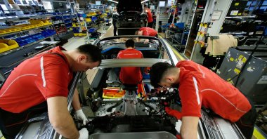 Employees of German car manufacturer Porsche work on a Porsche 911 at the Porsche factory, Stuttgart-Zuffenhausen, Germany, Feb. 19, 2019. (Reuters Photo)