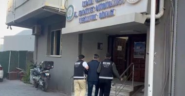 Police officers detain suspects during a corruption operation targeting Bayraklı Municipality, Izmir, Türkiye, Oct. 6, 2026. (DHA Photo)