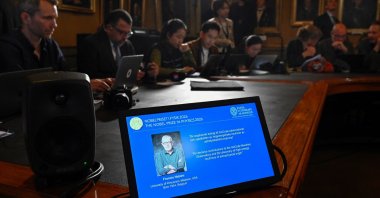 A display screen shows Francis Halzen is announced as the recipient of the 2026 Nobel Prize in Physics during a press conference at the Royal Swedish Academy of Sciences, Stockholm, Sweden, Oct. 6, 2026. (Reuters Photo)