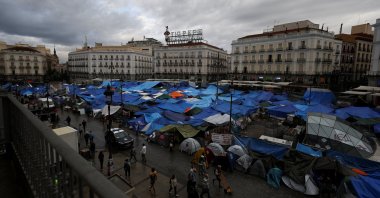 Demonstrators camp in Puerta del Sol square, demanding political action to stop evictions and address the housing crisis, following the eviction of an 87-year-old woman from her home, in Madrid, Spain, Oct. 6, 2026. (Reuters Photo)