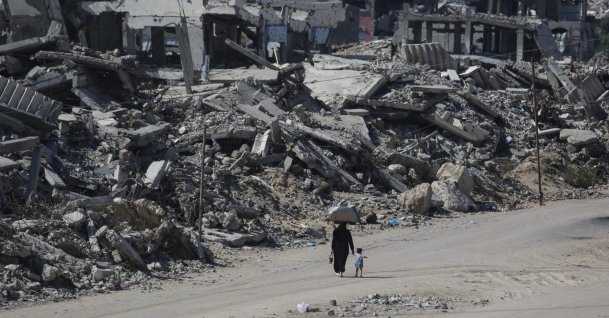 People walk along a street lined with destroyed buildings at the Jabalia refugee camp in the northern Gaza Strip, Palestine, Oct. 5, 2026. (AFP Photo)