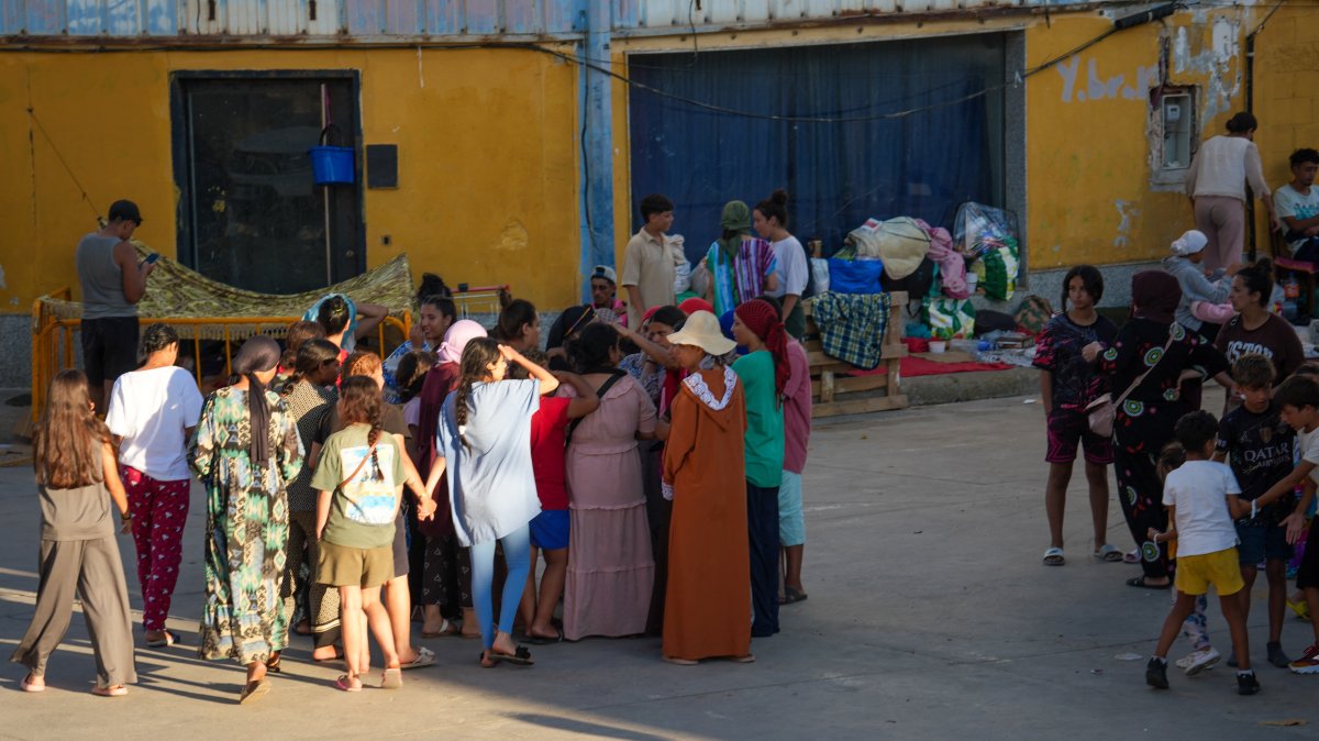 Women migrants and children gather in an industrial area in Ceuta, Spain, Aug. 3. (AFP File Photo)