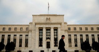 A man walks past the Federal Reserve in Washington, Dec. 16, 2015. (Reuters File Photo)