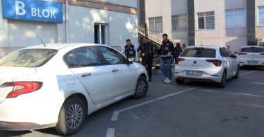 Security officers escort a suspect detained in an anti-corruption operation, Esenyurt, Istanbul, Türkiye, October 7, 2026. (DHA Photo)