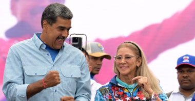 Venezuelan President and presidential candidate Nicolas Maduro dances next to his wife, Cilia Flores, at his campaign closing rally in Caracas, July 25, 2024. (AFP File Photo)