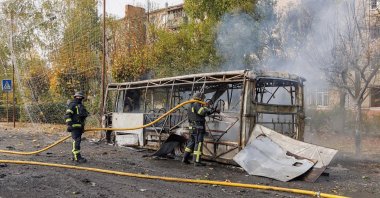 Firefighters working at the scene where two buses were struck by projectiles in Kramatorsk, eastern Ukraine, Oct. 8, 2026. (AFP Photo)