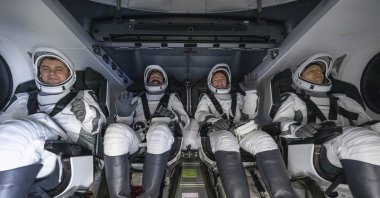 A handout picture made available by the National Aeronautics and Space Administration (NASA) shows Roscosmos cosmonaut Andrey Fedyaev, left, NASA astronauts Jack Hathaway and Jessica Meir, and ESA (European Space Agency) astronaut Sophie Adenot are seen inside the SpaceX Dragon Freedom spacecraft onboard the SpaceX recovery ship SHANNON shortly after having landed in the Pacific Ocean off the coast of Los Angeles, California, Oct. 8, 2026. (NASA Handout via EPA)