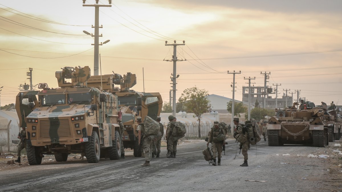 Soldiers and military vehicles are deployed at a staging area for the Turkish Armed Forces and the Turkish-backed Syrian National Army along the border with the Syrian town of Tall Abyad, Şanlıurfa, Türkiye, Oct. 1, 2019. (Getty Images photo)