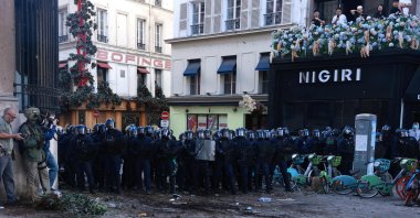 French police officers face protesters during a demonstration of high-school students at Place de la Bastille, Paris, France, Oct. 8, 2026. (AFP Photo)