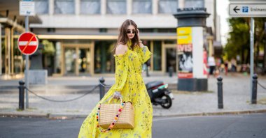 Maxilie Mlinarskij wearing a yellow maxi dress, Berlin, Germany, Aug. 5, 2018. (Getty Images Photo)
