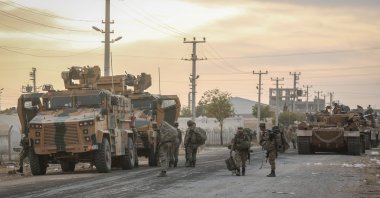 Soldiers and military vehicles are deployed at a staging area for the Turkish Armed Forces and the Turkish-backed Syrian National Army along the border with the Syrian town of Tall Abyad, Şanlıurfa, Türkiye, Oct. 1, 2019. (Getty Images photo)