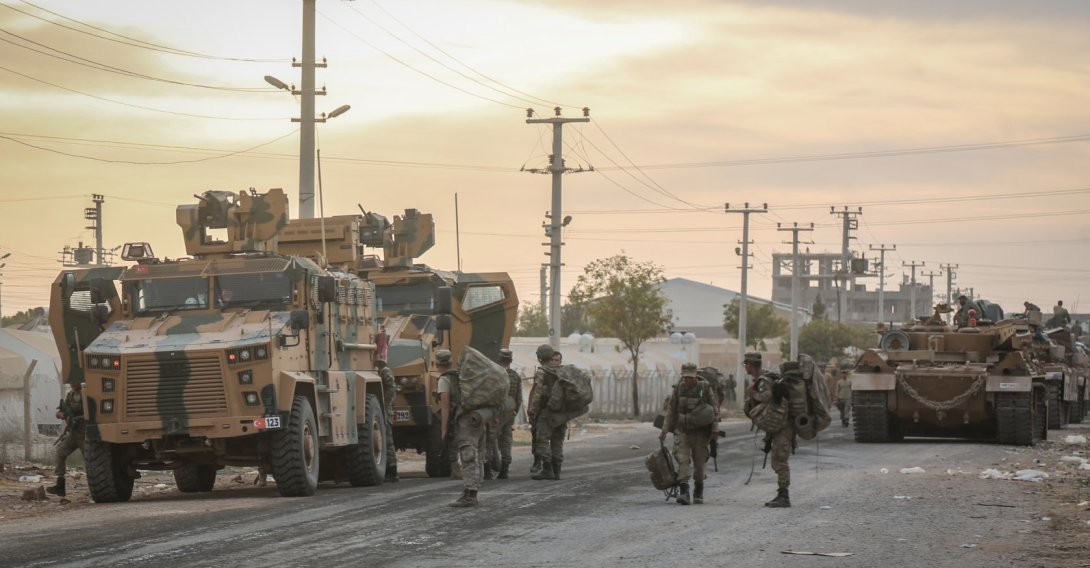 Soldiers and military vehicles are deployed at a staging area for the Turkish Armed Forces and the Turkish-backed Syrian National Army along the border with the Syrian town of Tall Abyad, Şanlıurfa, Türkiye, Oct. 1, 2019. (Getty Images photo)