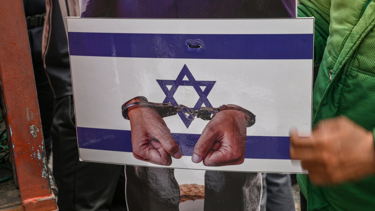 A replica depicting the hands of Israeli Prime Minister Benjamin Netanyahu in handcuffs is carried by protesters during a rally as part of a global day of action for Palestine, Ampang, Kuala Lumpur, Malaysia, Oct. 9, 2026. (EPA Photo)