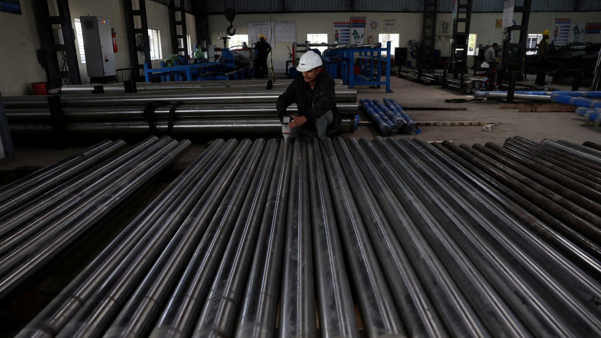 A worker checks the density of steel bars inside a steel factory, outskirts of Ahmedabad, India, Jan. 28, 2026. (Reuters Photo)
