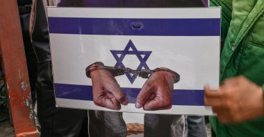 A replica depicting the hands of Israeli Prime Minister Benjamin Netanyahu in handcuffs is carried by protesters during a rally as part of a global day of action for Palestine, Ampang, Kuala Lumpur, Malaysia, Oct. 9, 2026. (EPA Photo)