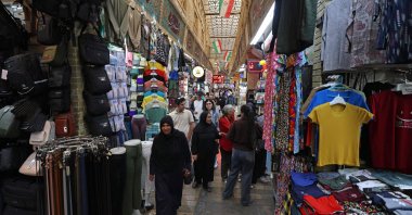 Shoppers walking through the Tajrish Bazaar. The marketplace in the Iranian capital's north would usually be abuzz with customers, but shops now sit mostly empty, with only small numbers of people walking its old, narrow paths, a jarring shift from the sellers shouting to promote their goods, Tehran, Iran, Oct. 7, 2026. (AFP Photo)