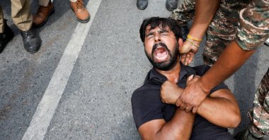 A protester is detained by security personnel during a protest by the Cockroach Janta Party (CJP) seeking the resignation of India's Chief Election Commissioner Gyanesh Kumar, New Delhi, India, Oct. 11, 2026. (Reuters Photo)