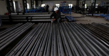 A worker checks the density of steel bars inside a steel factory, outskirts of Ahmedabad, India, Jan. 28, 2026. (Reuters Photo)