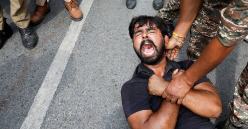 A protester is detained by security personnel during a protest by the Cockroach Janta Party (CJP) seeking the resignation of India's Chief Election Commissioner Gyanesh Kumar, New Delhi, India, Oct. 11, 2026. (Reuters Photo)
