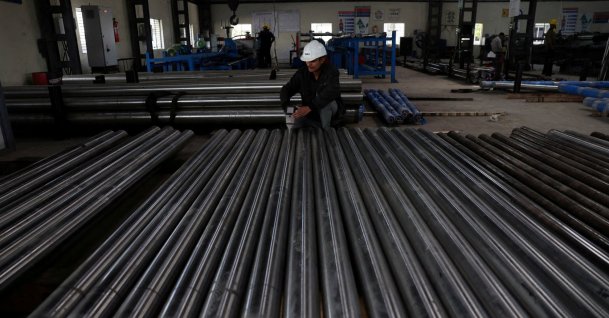 A worker checks the density of steel bars inside a steel factory, outskirts of Ahmedabad, India, Jan. 28, 2026. (Reuters Photo)