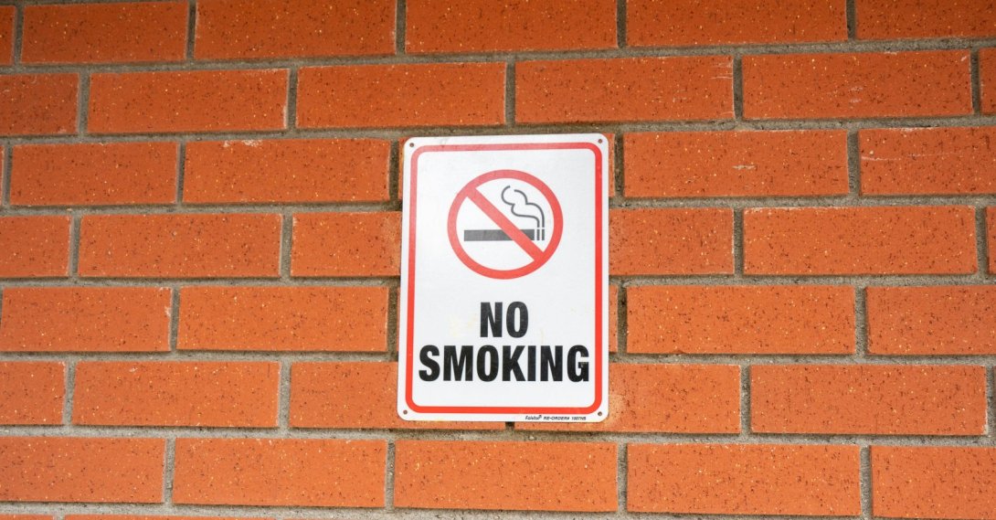 A no-smoking sign is on a wall of a building. (Shutterstock Photo)
