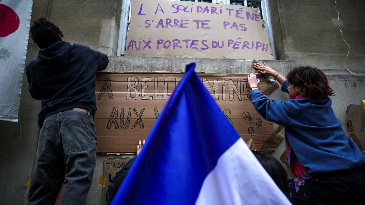 French university students stick posters on a wall at the Ecole des Mines, as part of nationwide protests to demand better school conditions in Paris, France, Oct. 9, 2026. (Reuters Photo)