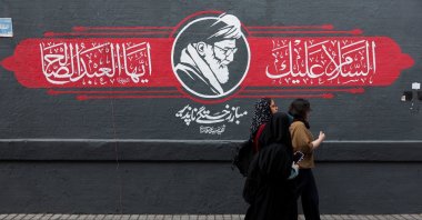 People walks past a mural depicting Iran's late Supreme Leader Ayatollah Ali Khamenei, in Tehran, Iran, Oct. 7, 2026. (Reuters Photo)