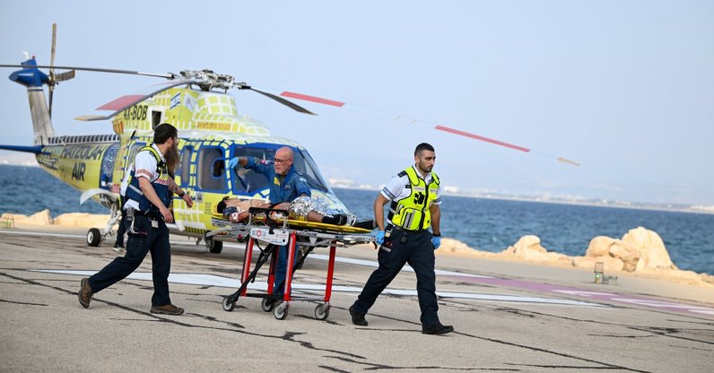Israeli paramedics transport an injured man after he arrived by helicopter from an incident involving an explosion in northern Israel, near the country's border with Lebanon, Haifa, Israel, Oct. 12, 2026. (Reuters Photo)
