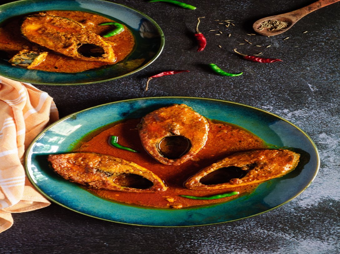 Hilsa fish Curry in a Red Cumin-paste Gravy in traditional Bengali style.