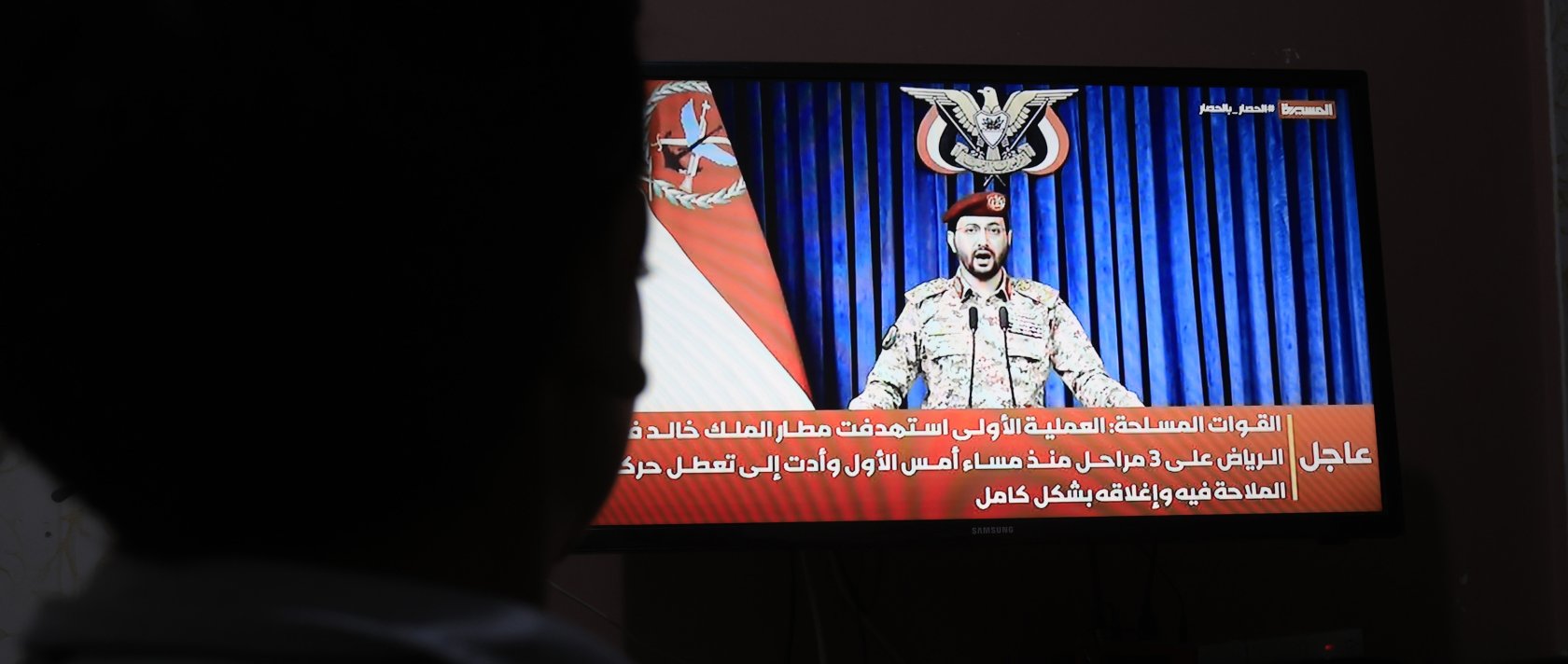 A person watches Houthi military spokesperson Yahya Sarea delivering a televised statement in Sanaa, Yemen, Oct. 11, 2026. (EPA Photo)