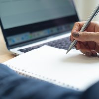 A woman studies on her laptop at home. (Shutterstock Photo)