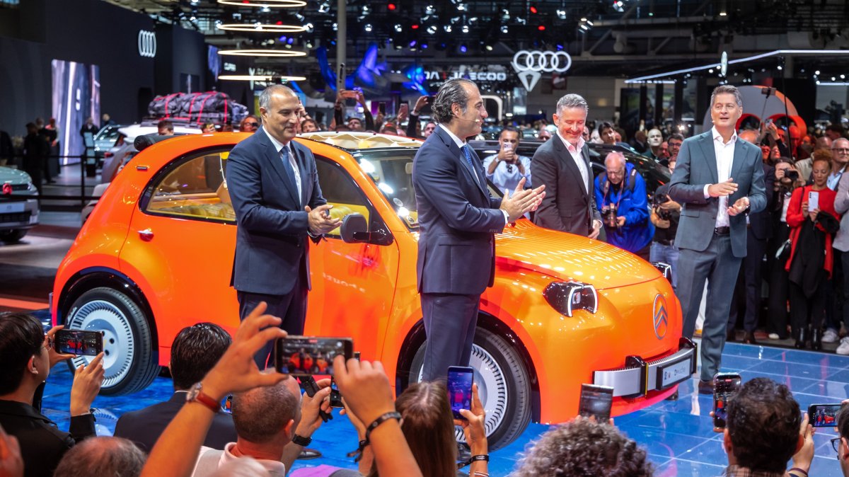 CEO of Citroen and DS Brands Xavier Chardon (R) and CEO of Stellantis Antonio Filosa (C) during the press presentation of the new 2CV car at the Paris Motor Show, Paris, France, Oct. 12, 2026. (EPA Photo)